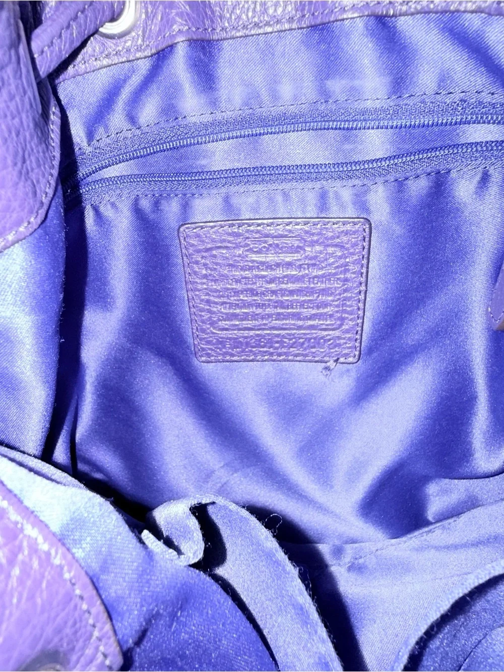 COACH purple pebbled bucket drawsting purse with slouchy silhouette.